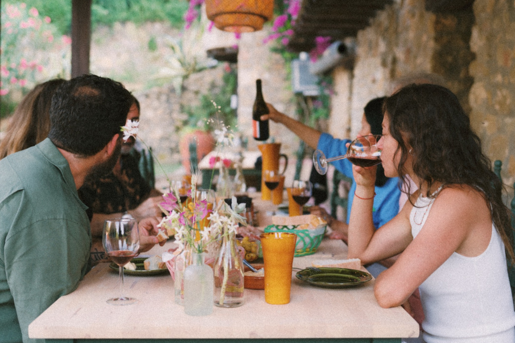 group drinking wine at outdoor table